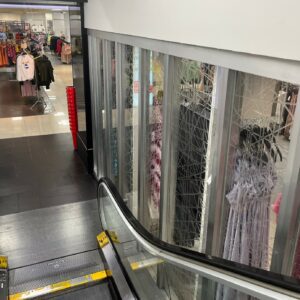 Century 21 escalator with transparent paneling.
