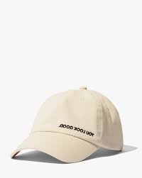 Glossier's "You Look Good." cap with inverted text that reads correctly in selfies.