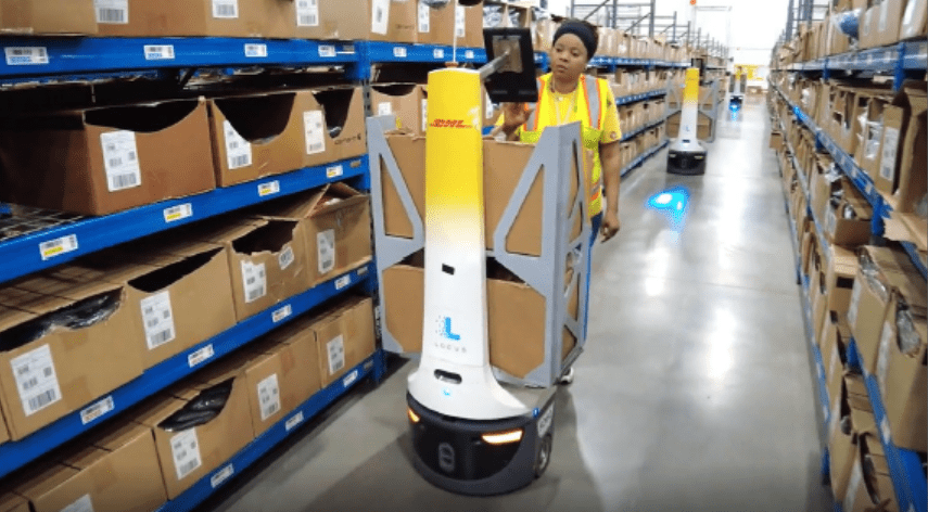 A Carhartt warehouse worker uses a Locus robot.